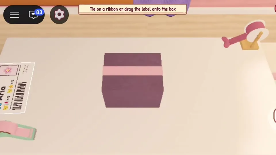 Closed box with prompt Tie on a ribbon or drag the label onto the box